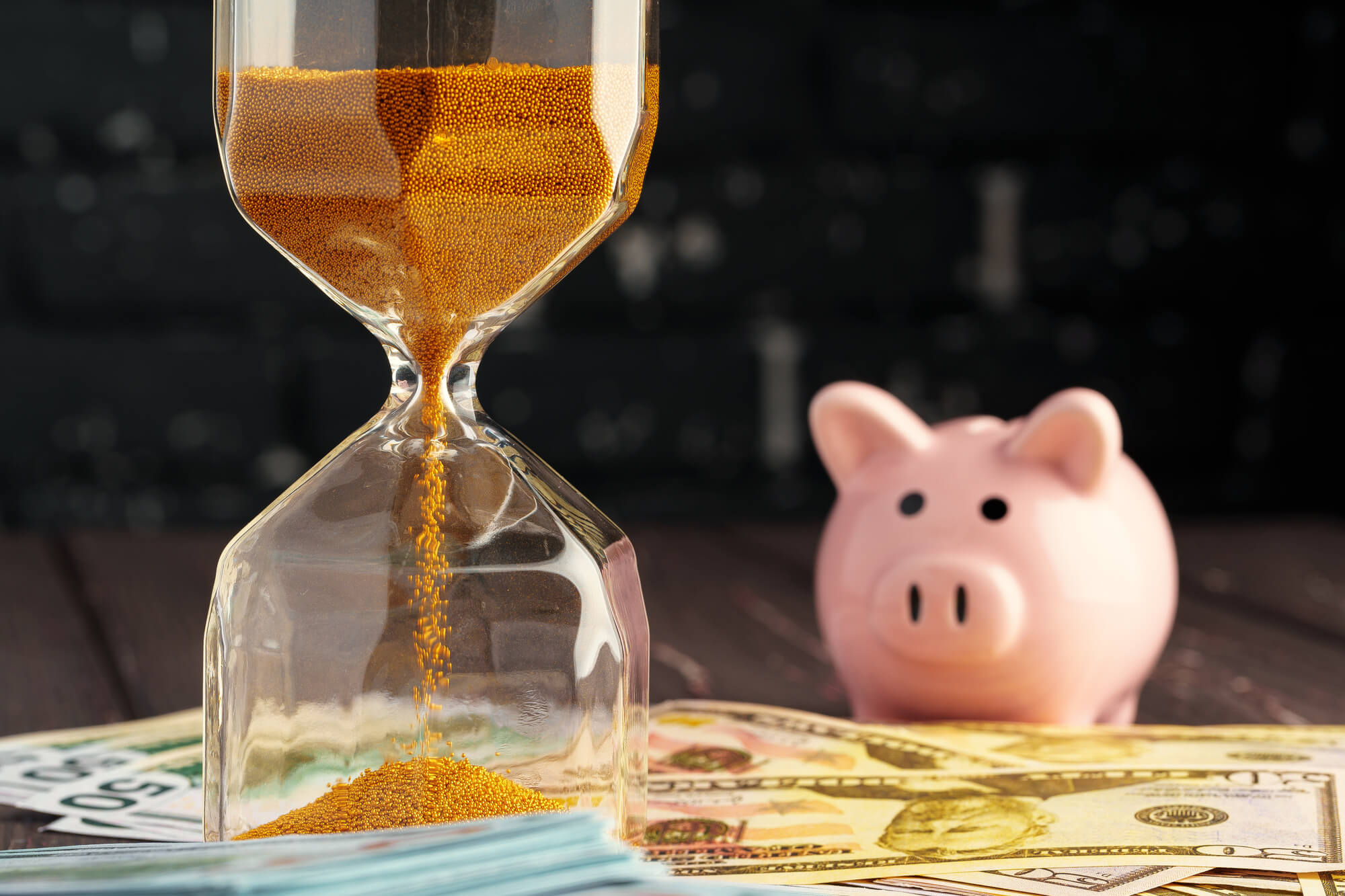 time-and-money-business-concept-sandglass-and-mon-2021-10-07-16-28-57-utc (1) (1)