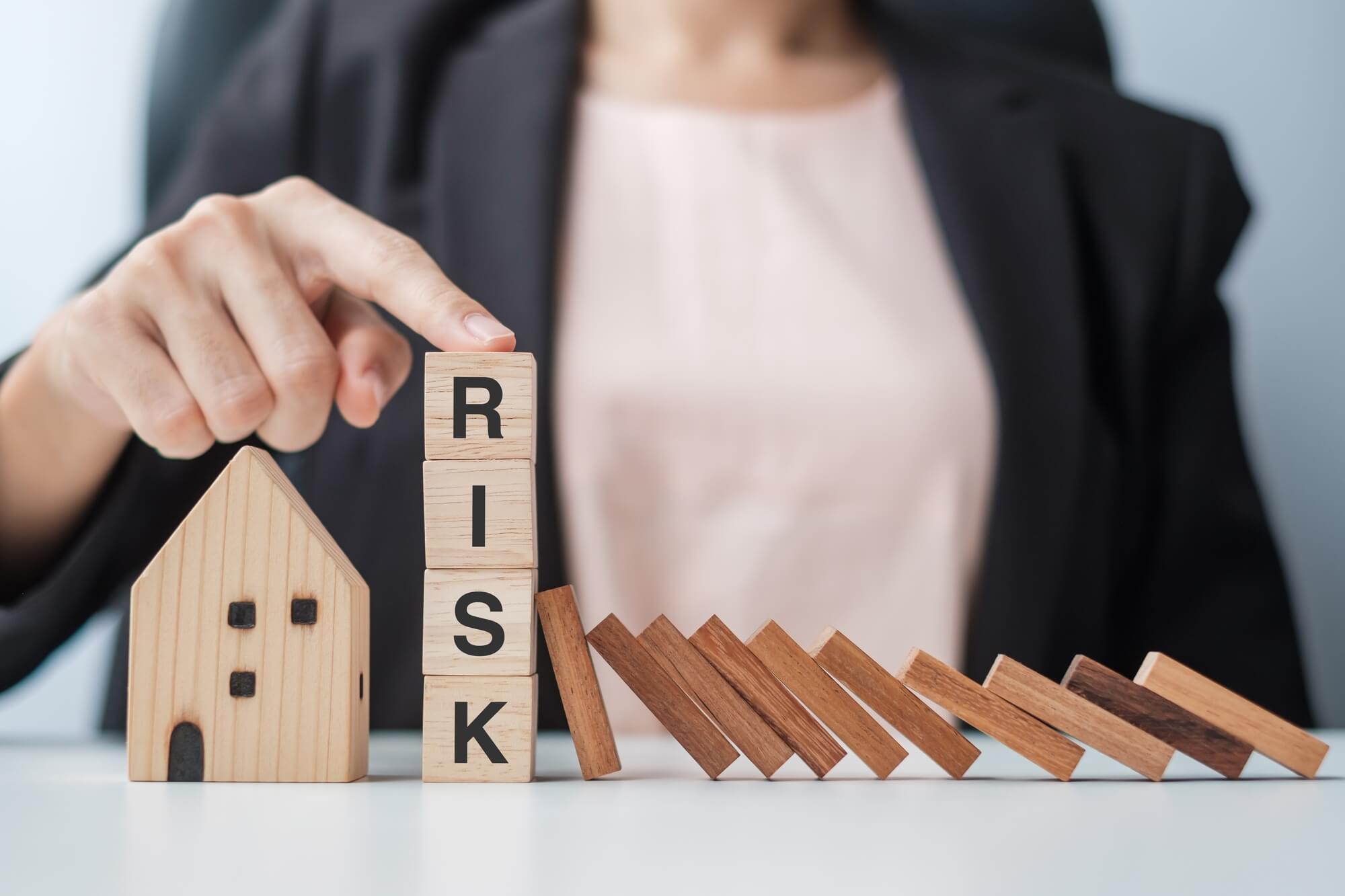 businessman-stop-falling-wooden-blocks-and-protect-2022-11-07-22-21-30-utc (1) (1)